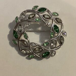 Beautiful Swarovski Silver Tone Wreath Brooch with green crystals.
